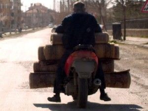 Motosikletiyle halı taşıyan sürücü hayrete düşürdü